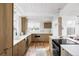 Modern kitchen with wooden cabinets, white countertops, and stainless steel appliances at 1459 S Filbert Way, Denver, CO 80222