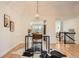 Dining area with hardwood floors, modern lighting, and views into the kitchen at 7452 W Cedar Cir, Lakewood, CO 80226