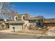 Charming home featuring a two-car garage, brick accents, complemented by landscaping at 7452 W Cedar Cir, Lakewood, CO 80226