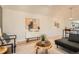 Bright living room featuring hardwood floors, modern decor, and a harmonious blend of style at 7452 W Cedar Cir, Lakewood, CO 80226