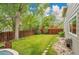 Lush backyard with mature trees, green lawn, and stone landscaping creating a serene outdoor oasis at 2140 W 135Th Ave, Westminster, CO 80234