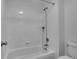 Bright bathroom with a tub, shower, and white tile surround at 2140 W 135Th Ave, Westminster, CO 80234