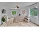 Primary bedroom featuring two windows with drapes, wood floors, and a ceiling fan at 2140 W 135Th Ave, Westminster, CO 80234