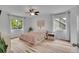 Primary bedroom with wood floors, a ceiling fan, two windows, and light colored walls at 2140 W 135Th Ave, Westminster, CO 80234