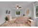 Primary bedroom with wood floors, two windows, a ceiling fan, and light colored walls at 2140 W 135Th Ave, Westminster, CO 80234