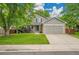 Charming two-story home with a well-manicured lawn, mature trees, and a two-car garage at 2140 W 135Th Ave, Westminster, CO 80234