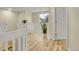 Upstairs hallway with wood floors, white railings, and natural light at 2140 W 135Th Ave, Westminster, CO 80234