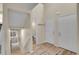 Hallway with staircase, wood floors, and access to bathroom and exterior doors at 2140 W 135Th Ave, Westminster, CO 80234