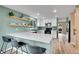 Updated kitchen with white countertops, modern appliances, and open shelving at 2140 W 135Th Ave, Westminster, CO 80234