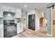 Updated kitchen features stainless steel appliances, white cabinetry, and modern countertops at 2140 W 135Th Ave, Westminster, CO 80234