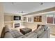 Cozy living room with a grey sectional couch, fireplace, TV and light wood floors at 2140 W 135Th Ave, Westminster, CO 80234