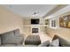 Cozy living room with a grey sectional couch, fireplace, TV and light wood floors at 2140 W 135Th Ave, Westminster, CO 80234