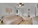 Bright main bedroom with hardwood floors, a ceiling fan, and an ensuite bathroom at 2140 W 135Th Ave, Westminster, CO 80234