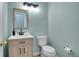 Powder room featuring a modern vanity, mirror, and toilet at 2140 W 135Th Ave, Westminster, CO 80234