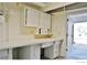Unfinished basement with white painted walls and pegboard cabinets above a workbench at 1333 S Eudora St, Denver, CO 80222