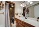 Bathroom featuring tile floors, tile shower, vanity with white countertop, and wooden cabinets at 1333 S Eudora St, Denver, CO 80222