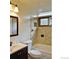 Bright bathroom features a window over the tub and decorative tile surround at 1333 S Eudora St, Denver, CO 80222