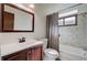Bathroom featuring tile floors, bathtub, vanity with white countertop, and wooden cabinets at 1333 S Eudora St, Denver, CO 80222
