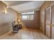 Bedroom featuring wood paneling, a rocking chair, wood floors, and bright natural light from a window at 1333 S Eudora St, Denver, CO 80222