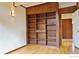 Bedroom featuring a built-in bookcase and hardwood flooring at 1333 S Eudora St, Denver, CO 80222