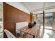 Open dining area with a rustic table and view to the outdoor, natural light for gatherings at 1333 S Eudora St, Denver, CO 80222