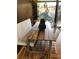 Dining area features rustic wooden table, bench seating, wood floors and decorative hanging lights at 1333 S Eudora St, Denver, CO 80222