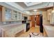 Bright kitchen features wood floors, cabinets, countertops, and modern black appliances at 1333 S Eudora St, Denver, CO 80222