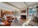 Open living room with a fireplace, large windows, and natural light with warm furnishings at 1333 S Eudora St, Denver, CO 80222