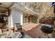 Cozy brick patio area with outdoor seating, string lights and mature landscaping at 1333 S Eudora St, Denver, CO 80222
