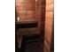 Wood paneled sauna interior with bench seating, built-in shelf, and tiled flooring at 1333 S Eudora St, Denver, CO 80222