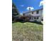 Backyard featuring a partially covered deck, mature tree, and green lawn with shade at 15983 E Loyola Dr, Aurora, CO 80013