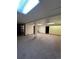 Spacious basement with neutral carpet, tile ceiling, and multiple doorways at 15983 E Loyola Dr, Aurora, CO 80013