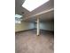 Spacious basement with neutral carpet, tile ceiling, and support beam at 15983 E Loyola Dr, Aurora, CO 80013