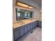 Bathroom featuring a double vanity with plentiful counter space and a large mirror at 15983 E Loyola Dr, Aurora, CO 80013