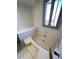 White bathtub with a window to allow natural light to filter in at 15983 E Loyola Dr, Aurora, CO 80013