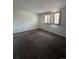 Empty bedroom features carpet, blinds on windows, and clean, white walls at 15983 E Loyola Dr, Aurora, CO 80013