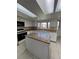 Bright kitchen with white cabinets, an island, and tile flooring at 15983 E Loyola Dr, Aurora, CO 80013