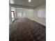 Large living room featuring plush carpeting, natural light, and an open layout at 15983 E Loyola Dr, Aurora, CO 80013
