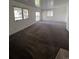Spacious living room with carpet flooring, lots of natural light, and a door to the backyard at 15983 E Loyola Dr, Aurora, CO 80013