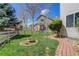 Backyard featuring a brick path, lawn, and fence surrounding the area at 19058 E Hickock Dr, Parker, CO 80134