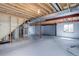 Spacious unfinished basement with utilities, open ceiling, and window at 19058 E Hickock Dr, Parker, CO 80134