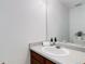 Bathroom features a clean single sink vanity, framed mirror and soft towels at 19058 E Hickock Dr, Parker, CO 80134