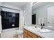 Cozy bathroom with black tiled shower/tub and neutral color scheme at 19058 E Hickock Dr, Parker, CO 80134