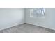 Bright bedroom with plush carpet, a sun-filled window and neutral walls at 19058 E Hickock Dr, Parker, CO 80134