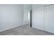 Bedroom with neutral carpet, closet and open door to the hallway at 19058 E Hickock Dr, Parker, CO 80134