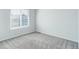 Bedroom features plush carpet, neutral walls, and a sun-filled window at 19058 E Hickock Dr, Parker, CO 80134
