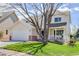 Inviting two-story home featuring a covered porch, mature tree, and attached two-car garage at 19058 E Hickock Dr, Parker, CO 80134