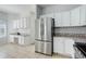 View of the kitchen with stainless steel refrigerator and a built-in desk area at 19058 E Hickock Dr, Parker, CO 80134