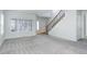Bright living room with plush carpet, a staircase and a large window at 19058 E Hickock Dr, Parker, CO 80134