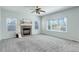 Bright living room featuring a stone fireplace and large windows with blinds at 19058 E Hickock Dr, Parker, CO 80134